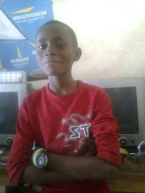 Adetola as a teenager learning computers